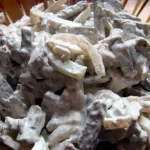 Язик з грибами під горіховим соусом