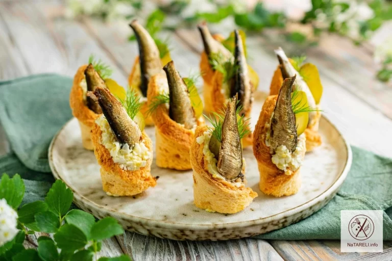 Envelopes made of toast bread with sprats and pickled cucumbers