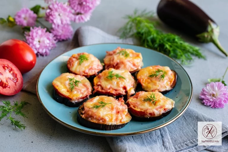 Eggplants baked with tomatoes, boiled sausage and hard cheese in the oven