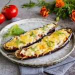 Baked eggplant boats with satsebeli sauce and cheese